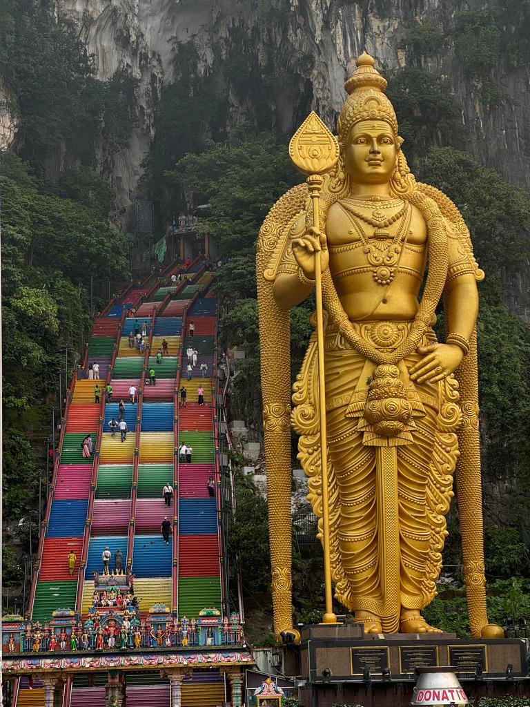 Lord Murugan statue and rainbow stairs at Batu Caves.