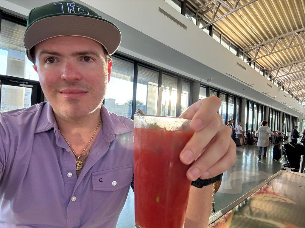 Bloody Mary at Tampa airport, Rays baseball cap on the table.