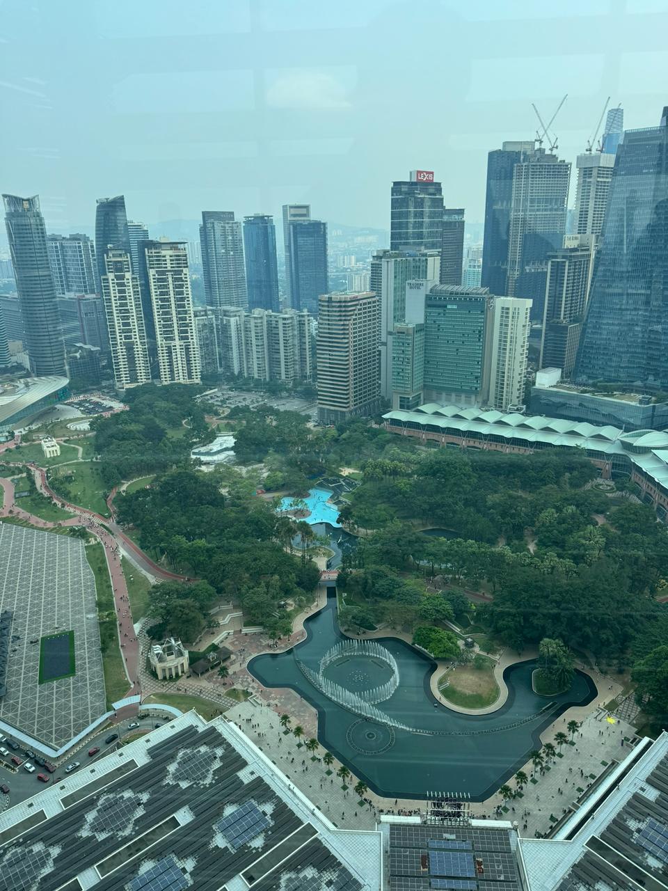 KLCC Park from the Petronas Towers observation deck, star fountain and city towers.