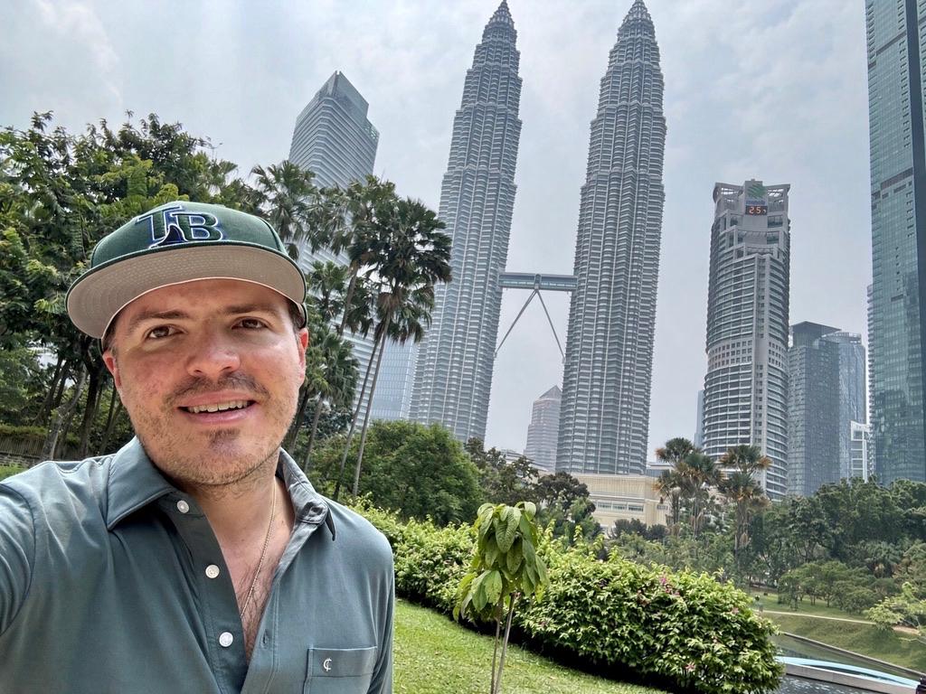 Selfie at KLCC Park with the Petronas Towers behind, haze on the skyline.