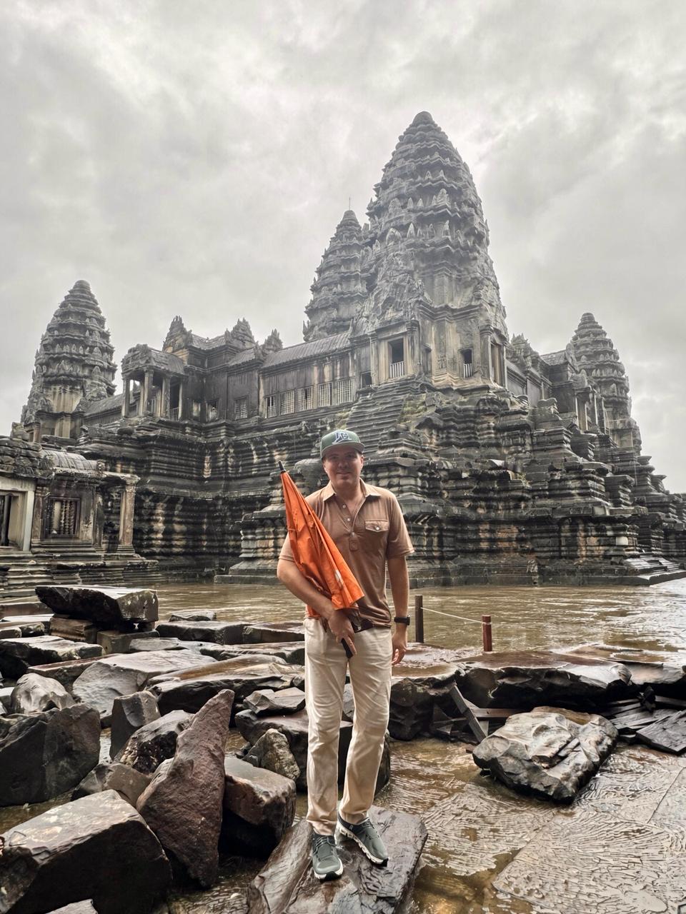 Orange umbrella, flooded courtyard, Angkor Wat.