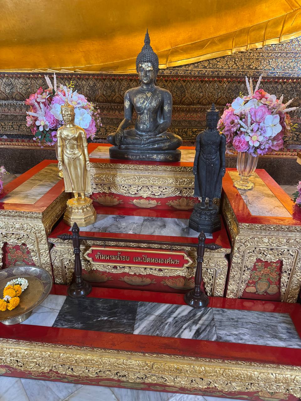 Small Buddha statues on an altar at Wat Pho.